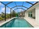 Inviting screened-in pool area with clear blue water, lounge chairs, and ample space for relaxation and outdoor enjoyment at 180 Rotonda N Blvd, Rotonda West, FL 33947