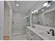 Modern bathroom with marble tiling, glass shower, double vanity, and black fixtures at 1801 N Morgan St # 5, Tampa, FL 33602