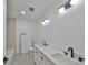 Bright bathroom with a double sink vanity, quartz countertops, and modern fixtures at 1801 N Morgan St # 5, Tampa, FL 33602