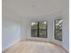 Light-filled bedroom with modern hardwood floors, large windows, and a minimalist design at 1801 N Morgan St # 5, Tampa, FL 33602