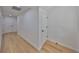 Clean hallway featuring hardwood floors, white walls, and modern doors at 1801 N Morgan St # 5, Tampa, FL 33602