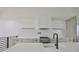 Bright, modern kitchen with white cabinets, quartz countertops, and stainless steel appliances at 1801 N Morgan St # 5, Tampa, FL 33602