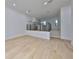 Open-concept living room with hardwood floors and modern railings to kitchen at 1801 N Morgan St # 5, Tampa, FL 33602