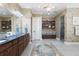 Elegant bathroom with dual sinks, custom cabinetry, and a walk-in shower at 18258 Wayne Rd, Odessa, FL 33556