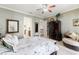 Lovely bedroom with a queen bed, a large dark wooden dresser and a cozy sitting area at 18258 Wayne Rd, Odessa, FL 33556