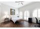 This bedroom features high ceilings, shuttered arched windows, wood floors, and a refined decor, creating an elegant space at 18258 Wayne Rd, Odessa, FL 33556