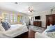 Bright and spacious bedroom with hardwood floors, access to a balcony, and a cozy sitting area at 18258 Wayne Rd, Odessa, FL 33556
