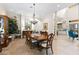Formal dining room featuring tile floors, a chandelier, and classic furnishings adjacent to the kitchen at 18258 Wayne Rd, Odessa, FL 33556