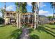 Beautiful backyard with lush landscaping, patio, screened-in pool, and lake view at 18258 Wayne Rd, Odessa, FL 33556