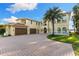 Elegant two-story home with a three-car garage, beautiful landscaping, and a circular brick driveway at 18258 Wayne Rd, Odessa, FL 33556