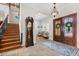 Grand foyer featuring a beautiful staircase, grandfather clock, tile flooring, and decorative glass double front doors at 18258 Wayne Rd, Odessa, FL 33556