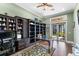 This office features custom built-ins, hardwood flooring, and glass doors leading to an outdoor space at 18258 Wayne Rd, Odessa, FL 33556