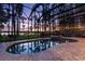 A luxurious screened-in pool and spa offer beautiful lake views and tranquil sunsets at 18258 Wayne Rd, Odessa, FL 33556