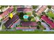 Aerial view of residential buildings and a community pool nestled among lush greenery and parking spaces at 2593 Countryside Blvd # 7305, Clearwater, FL 33761