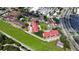 Wide aerial view of community, with pool, tennis court, and surrounding commercial areas at 2593 Countryside Blvd # 7305, Clearwater, FL 33761