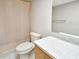 Cozy bathroom with a toilet, shower with curtain, and a mirrored vanity with solid surface counter at 2593 Countryside Blvd # 7305, Clearwater, FL 33761