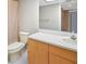 Bright bathroom featuring a toilet, vanity with storage, and a large mirror at 2593 Countryside Blvd # 7305, Clearwater, FL 33761
