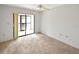 Bright bedroom with a ceiling fan and sliding glass doors to a patio at 2593 Countryside Blvd # 7305, Clearwater, FL 33761