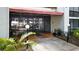 Exterior entrance with tiled walkway, covered awning, and glass doors leading into the building at 2593 Countryside Blvd # 7305, Clearwater, FL 33761