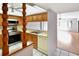 Kitchen with wooden cabinets, stainless steel appliances, and tiled floors that connects to a living room space at 2593 Countryside Blvd # 7305, Clearwater, FL 33761