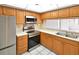 Bright kitchen with stainless steel appliances, light countertops, and wooden cabinets at 2593 Countryside Blvd # 7305, Clearwater, FL 33761