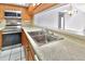 Open kitchen layout with stainless steel appliances, a double sink, and light-colored countertops at 2593 Countryside Blvd # 7305, Clearwater, FL 33761