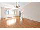Spacious living room boasts wood-look floors, a ceiling fan, and a sliding glass door for natural light at 2593 Countryside Blvd # 7305, Clearwater, FL 33761