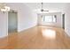 Bright living room features wood-look floors, a ceiling fan, and a large window for natural light at 2593 Countryside Blvd # 7305, Clearwater, FL 33761