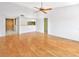 Bright open living room with hardwood floors and a ceiling fan at 2593 Countryside Blvd # 7305, Clearwater, FL 33761