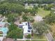 Aerial shot of home featuring solar panels and circular driveway, surrounded by lush trees at 2704 Dorene Dr, Plant City, FL 33563