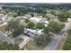Overhead neighborhood view showing a home with solar panels and circular driveway nestled among mature trees at 2704 Dorene Dr, Plant City, FL 33563