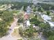 Aerial view of a neighborhood featuring a home with solar panels and circular driveway at 2704 Dorene Dr, Plant City, FL 33563