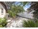 Fenced backyard with an air conditioning unit, garden bed, and a white wooden fence at 2704 Dorene Dr, Plant City, FL 33563