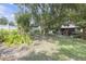 A beautiful backyard with lush landscaping, a covered patio, and a gazebo in the distance at 2704 Dorene Dr, Plant City, FL 33563