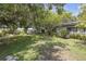 Spacious backyard with mature trees and lush green grass providing a serene outdoor space at 2704 Dorene Dr, Plant City, FL 33563