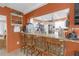 Bar featuring a granite countertop with seating, opening to a bright and modern kitchen at 2704 Dorene Dr, Plant City, FL 33563