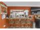 Bar with granite countertop and seating that opens to a kitchen space beyond at 2704 Dorene Dr, Plant City, FL 33563