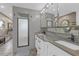 Bathroom featuring a double sink vanity with granite countertop and tiled shower at 2704 Dorene Dr, Plant City, FL 33563