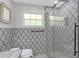 A sleek bathroom offers a glass-enclosed shower and modern design, combining style with functionality at 2704 Dorene Dr, Plant City, FL 33563