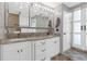 Bathroom features a double sink vanity, large mirror, and beautifully tiled floors at 2704 Dorene Dr, Plant City, FL 33563