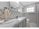 Updated bathroom featuring patterned tile, stylish vanity, and modern fixtures, creating a spa-like experience at 2704 Dorene Dr, Plant City, FL 33563