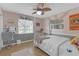 Charming bedroom featuring wood-look flooring, soft pink walls, and a four-poster bed at 2704 Dorene Dr, Plant City, FL 33563