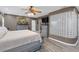 Spacious bedroom featuring a ceiling fan, glass block wall, and luxury vinyl plank flooring at 2704 Dorene Dr, Plant City, FL 33563