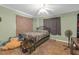 A cozy bedroom features wood-look floors, decorative curtains, and a ceiling fan, creating a private retreat at 2704 Dorene Dr, Plant City, FL 33563