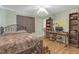 A cozy bedroom features wood-look floors, decorative curtains, and a ceiling fan, creating a private retreat at 2704 Dorene Dr, Plant City, FL 33563