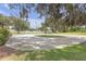 Circular driveway with mature trees and landscaped lawn at 2704 Dorene Dr, Plant City, FL 33563