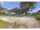 Circular driveway lined with mature trees and lush landscaping at 2704 Dorene Dr, Plant City, FL 33563