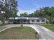 Charming single-story home with a circular driveway and solar panels on the roof at 2704 Dorene Dr, Plant City, FL 33563