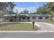 Charming single-story home with solar panels, neutral paint, mature landscaping, and a circular driveway at 2704 Dorene Dr, Plant City, FL 33563