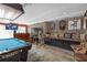 Entertain in this spacious game room with its pool table, a bar, and a unique stone accent wall at 2704 Dorene Dr, Plant City, FL 33563